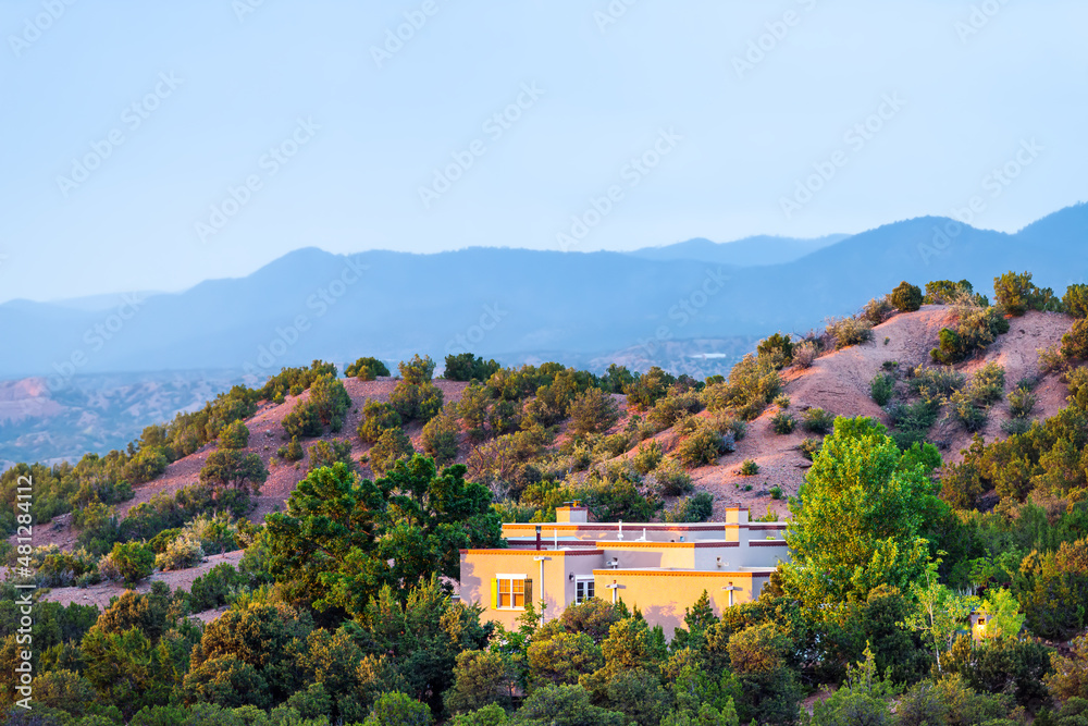 Fototapeta premium High desert mountain house home during summer sunset and twilight blue hour in Santa Fe, New Mexico