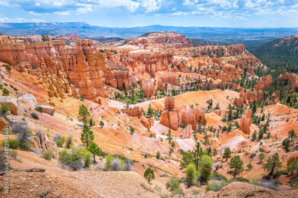 Landscape high angle aerial view from Sunset Point Overlook cliff at Bryce Canyon National Park in Utah with orange red rock valley view and blue sky Landscape high angle aerial view from Sunset Point Overlook cliff at Bryce Canyon National Park in Utah with orange red rock valley view and blue sky