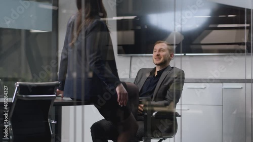 Sexual relationship and flirt at office. Young sensual lady seducing her busy male colleague, slow motion