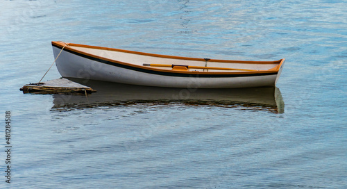 a row boat tied up in the harbor
