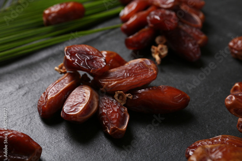 Tasty sweet dried dates on black table, closeup