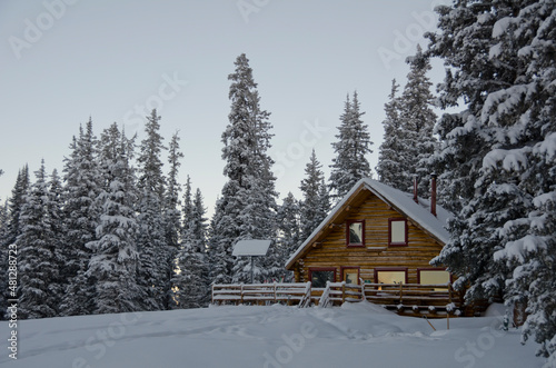 A snowy mountain cabin at dawn  © Brian