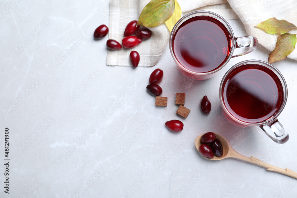 Flat lay composition with fresh dogwood tea and berries on light grey table. Space for text Flat lay composition with fresh dogwood tea and berries on light grey table. Space for text