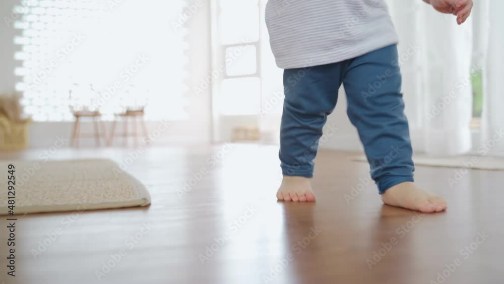 Happy Asian toddler boy having fun with walking and running on the floor. Development, First steps. Happy Asian toddler boy having fun with walking and running on the floor. Development, First steps.