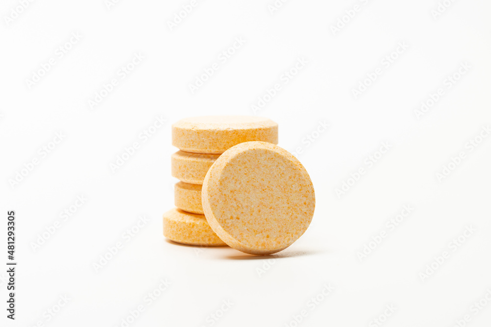 Image of orange soluble tablet or pills isolated on white background. This type of tablet can dissolve in water.  usually for vitamin, supplement or medicine.  - obrazy, fototapety, plakaty 