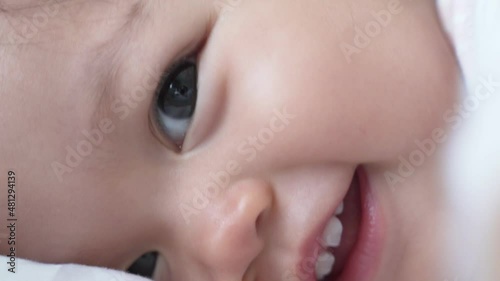 closeup baby infant blinking eyes and smile after drink milk from bottle. kid eye blink. happy smile baby face. asian child.