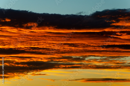 Bright orange clouds at sunset, like lava. © Irina Podoplelova