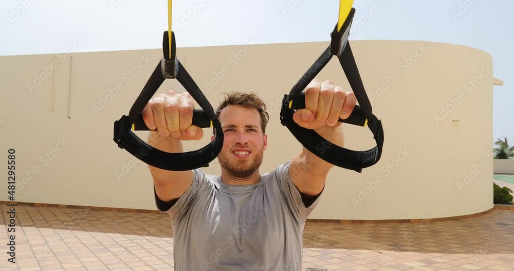 Suspension straps exercises man training arms workout at outdoor gym