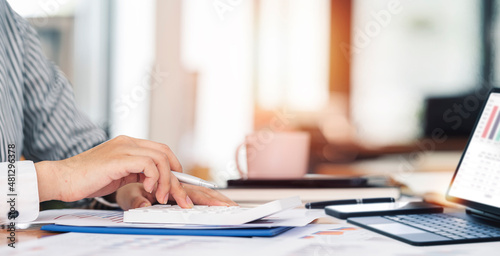 Businesswoman working at office with documents on her desk, doing planning analyzing the financial report, business plan investment, finance analysis concept.
