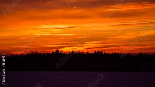 Beautiful winter morning landscape of Northern Europe rural area. Snowy scenery during sunrise.