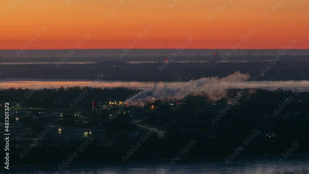 aerial pollution smoke stack during early morning with orange sky in background aerial pollution smoke stack during early morning with orange sky in background