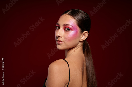 Portrait of beautiful young woman black t shirt pink makeup cosmetics fashion close-up unaltered