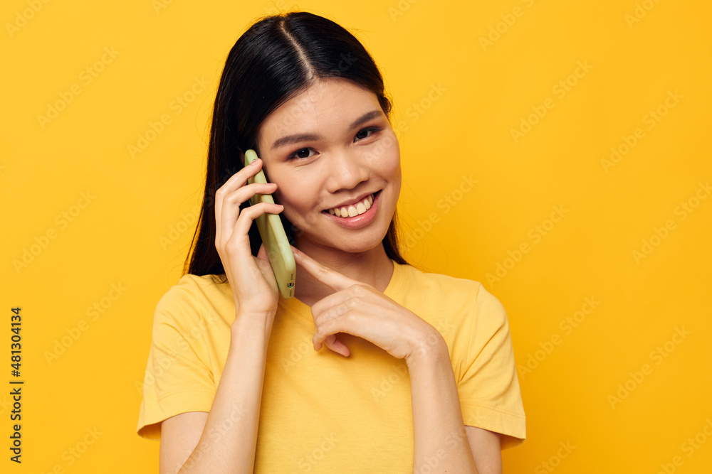 Charming young Asian woman phone communication fun use isolated background unaltered Charming young Asian woman phone communication fun use isolated background unaltered