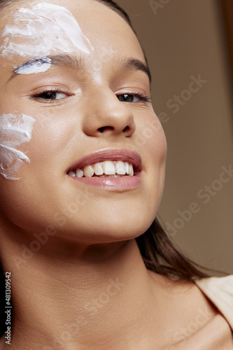 Portrait Woman applying a soothing face mask skin care close-up