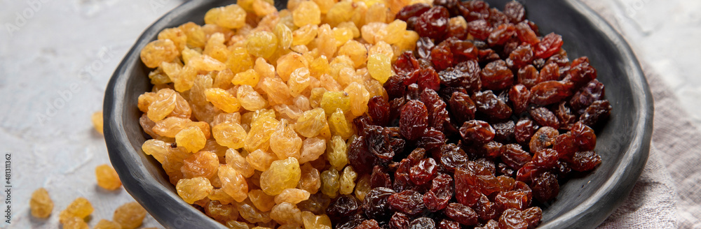 Golden and brown raisins on light background. Dried Fruits. Top view, flat lay, copy space Golden and brown raisins on light background. Dried Fruits. Top view, flat lay, copy space