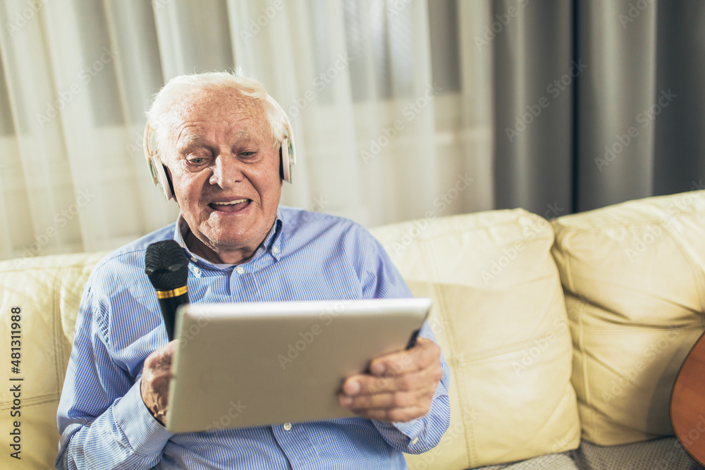 Senior man using microphone and singing karaoke Senior man using microphone and singing karaoke
