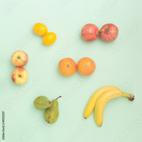 Fototapeta Naklejka Na Ścianę i Meble -  Fruit in pairs on pastel background. Top view.