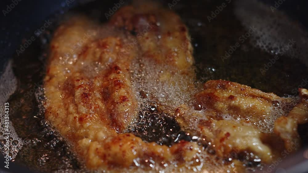 Close up Cooking deep fried crispy belly pork in boiling hot oil at the kitchen Close up Cooking deep fried crispy belly pork in boiling hot oil at the kitchen