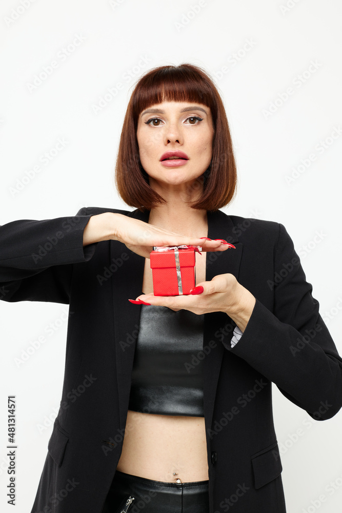 attractive woman in a black jacket red nail polish holiday gift Lifestyle unaltered attractive woman in a black jacket red nail polish holiday gift Lifestyle unaltered