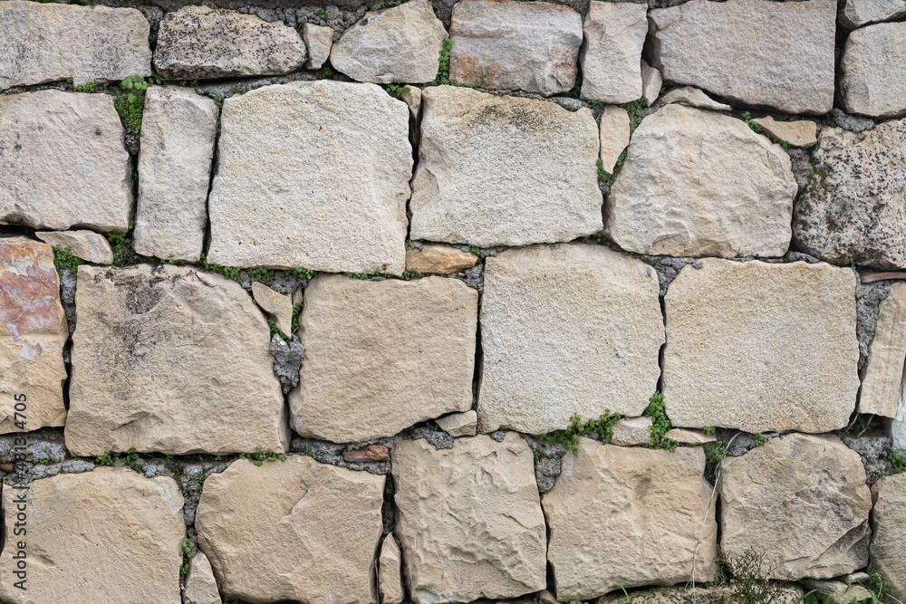 Background of brown-gray stone wall with leaves and moss . Pattern of slate wall texture and background Background of brown-gray stone wall with leaves and moss . Pattern of slate wall texture and background
