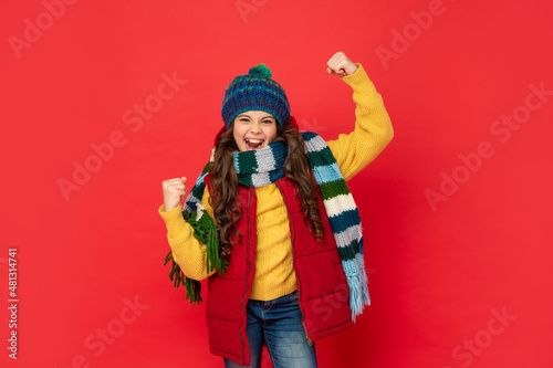 glad successful kid with curly hair in hat. female fashion model. teen girl in scarf.