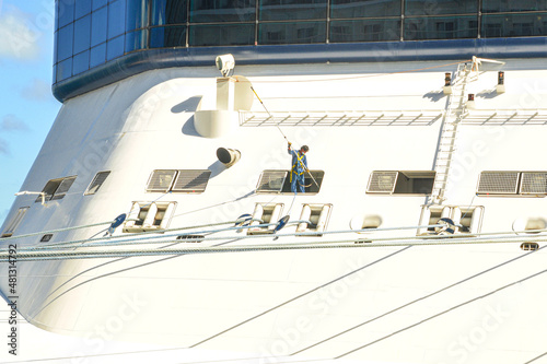 06-12-2021, Costa Maya, Mexico, 
A worker cleaning and working on cruise ship deck with precautions | Cruise ship worker cleaning cruise from outside on deck on mooring cables image background 