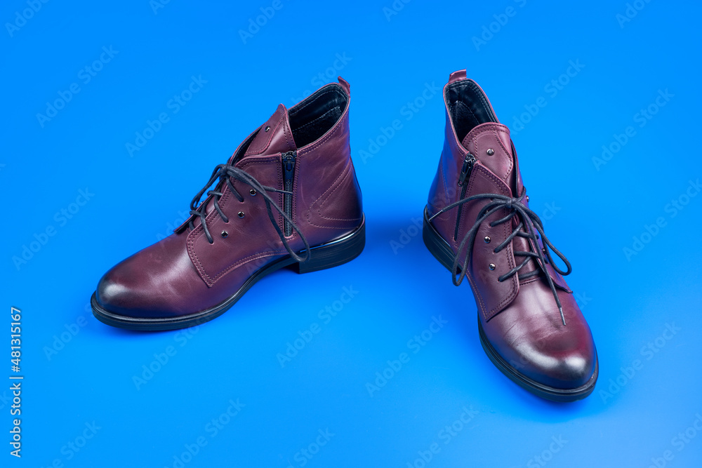 ankle boots on blue background. shoe store. shopping concept. female leather stylish footwear