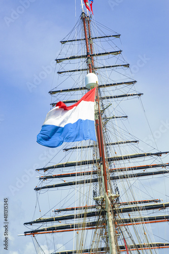 Flag of Kingdom of Netherlands Sint Marteen waving on sailboat Stad Amsterdam Image background | Sailboat with a flag of Sint Maarten, Kingdom of Netherlands 