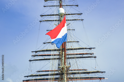 Flag of Kingdom of Netherlands Sint Marteen waving on sailboat Stad Amsterdam Image background | Sailboat with a flag of Sint Maarten, Kingdom of Netherlands 