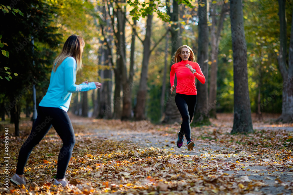 Woman Exercising in Public Park with Personal Trainer. Trainer Cheering and Woman Running Woman Exercising in Public Park with Personal Trainer. Trainer Cheering and Woman Running