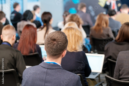 Businessman in conference hall with colleagues