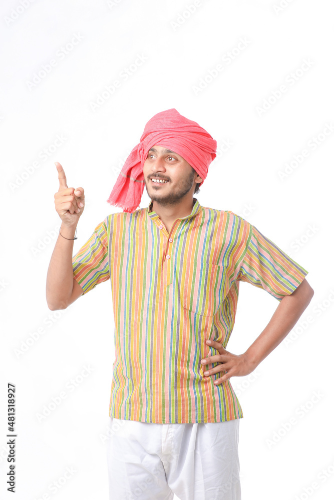 Young indian farmer in traditional wear and giving expression on white background. Young indian farmer in traditional wear and giving expression on white background.