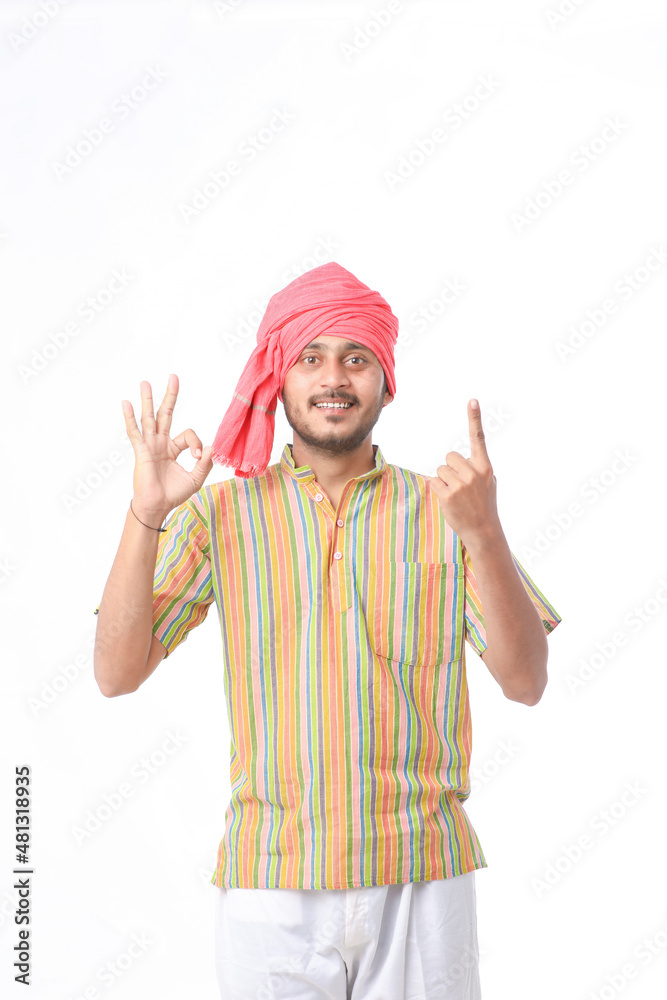 Young indian farmer in traditional wear and giving expression on white background. Young indian farmer in traditional wear and giving expression on white background.
