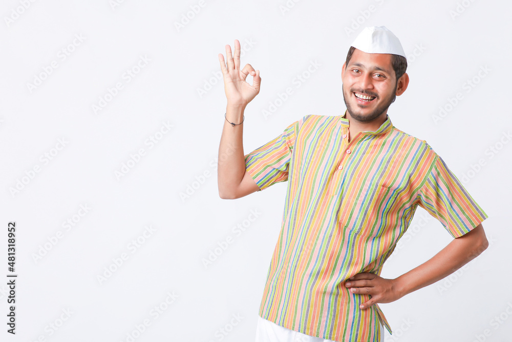 Young indian farmer in traditional wear and giving expression on white background. Young indian farmer in traditional wear and giving expression on white background.