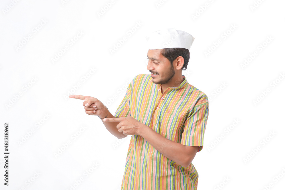 young indian man in traditional wear and showing direction on white background