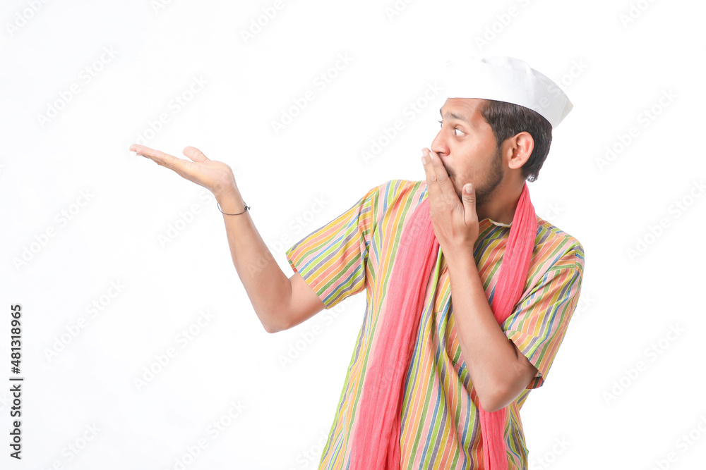 Young indian farmer in traditional wear and giving expression on white background. Young indian farmer in traditional wear and giving expression on white background.