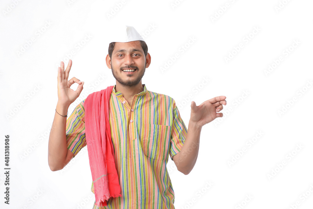 Young indian farmer in traditional wear and giving expression on white background. Young indian farmer in traditional wear and giving expression on white background.