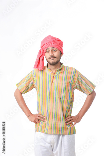 Young indian farmer in traditional wear and giving expression on white background.
