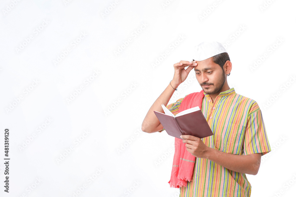 Indian farmer using diary on white background.