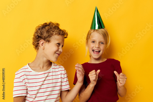 Cute preschool kids holiday fun with caps on your head yellow background