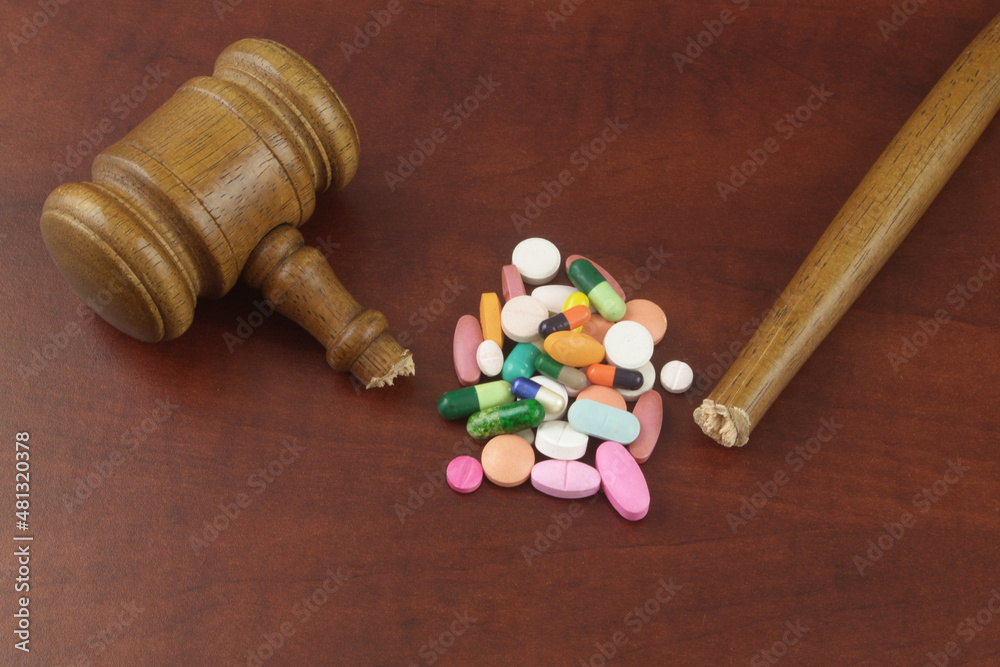 Not working laws and medicine concept. Heap of drugs and broken judge gavel. Not working laws and medicine concept. Heap of drugs and broken judge gavel.