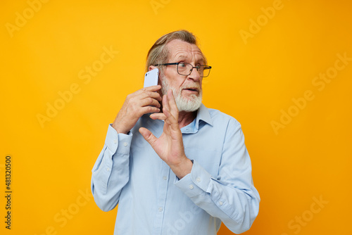 elderly man talking on the phone emotions isolated background © Tatiana