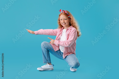 Little redhead girl in stri...