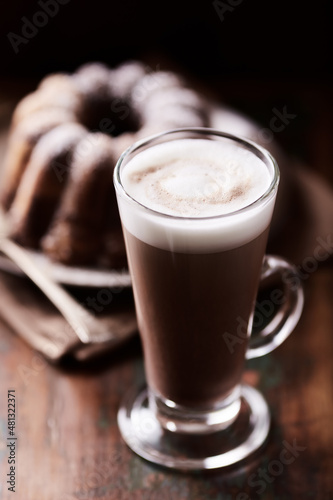 Coffee with milk on wooden background. Soft focus. Close up. 