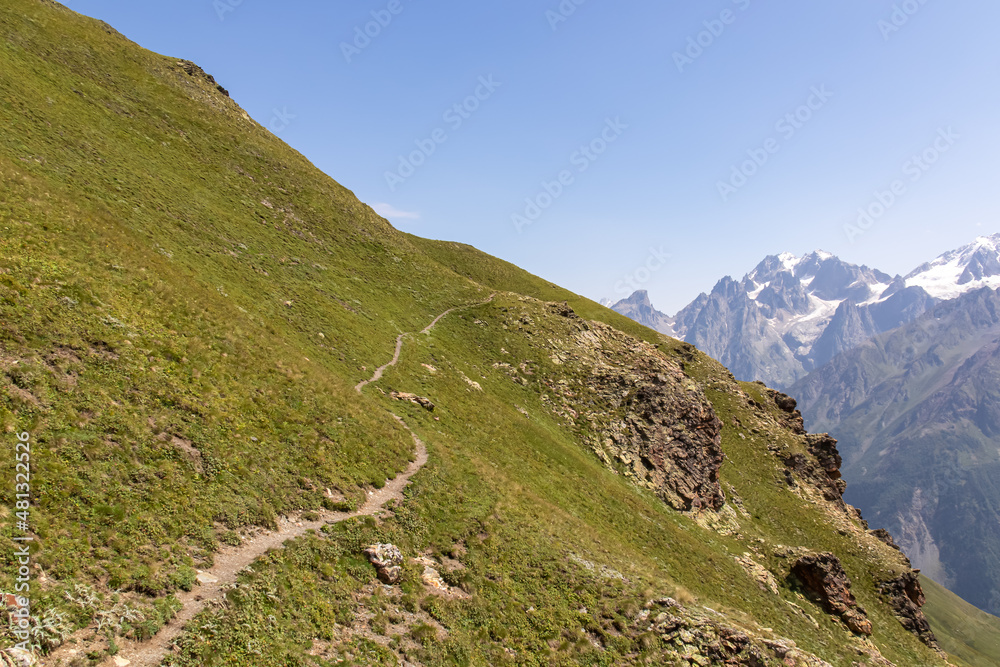A panoramic hiking trail starting at the Koruldi Lakes in the Greater Caucasus Mountain Range in Georgia, Samegrelo-Upper Svaneti Region. Alpine pasture along the path. Wanderlust. Remote location
