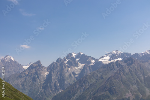 An amazing panoramic view on the mountain ridges near Mestia in the Greater Caucasus Mountain Range, Samegrelo-Upper Svaneti, Country of Georgia. The sharp peaks are covered in snow. Wanderlust