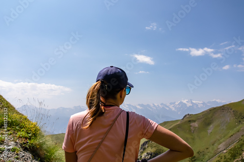 A woman enjoying the amazing views on the mountain ridges in the Greater Caucasus Mountain Range in Georgia, Samegrelo-Upper Svaneti Region. Alpine pasture along the path. Wanderlust. Koruldi Lakes