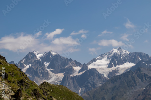 An amazing panoramic view on the mountain ridges near Mestia in the Greater Caucasus Mountain Range, Samegrelo-Upper Svaneti, Country of Georgia. The sharp peaks are covered in snow. Wanderlust photo
