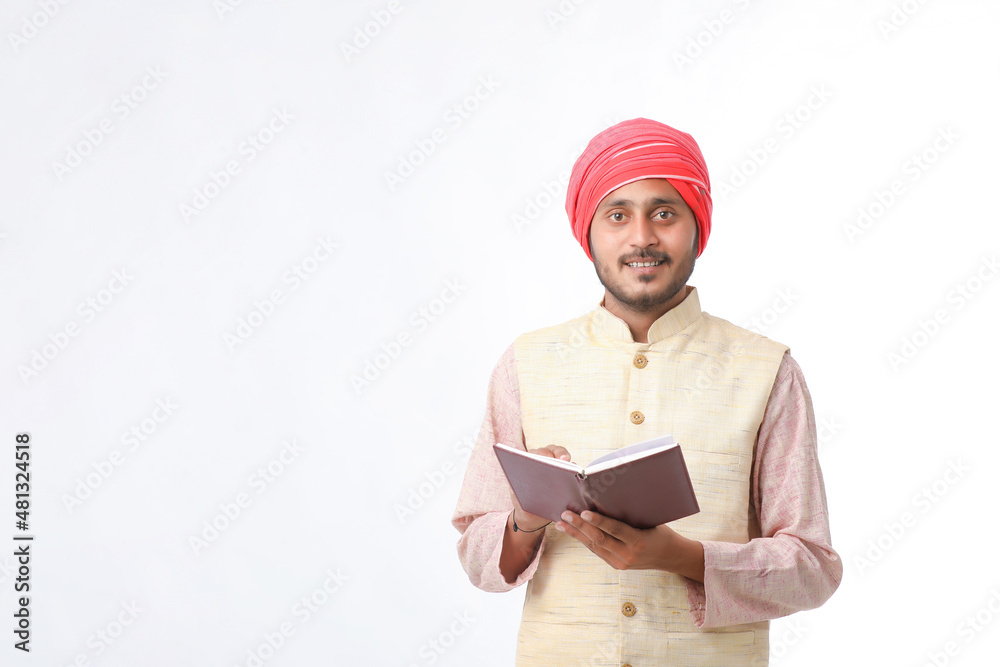 Indian farmer using diary on white background. Indian farmer using diary on white background.