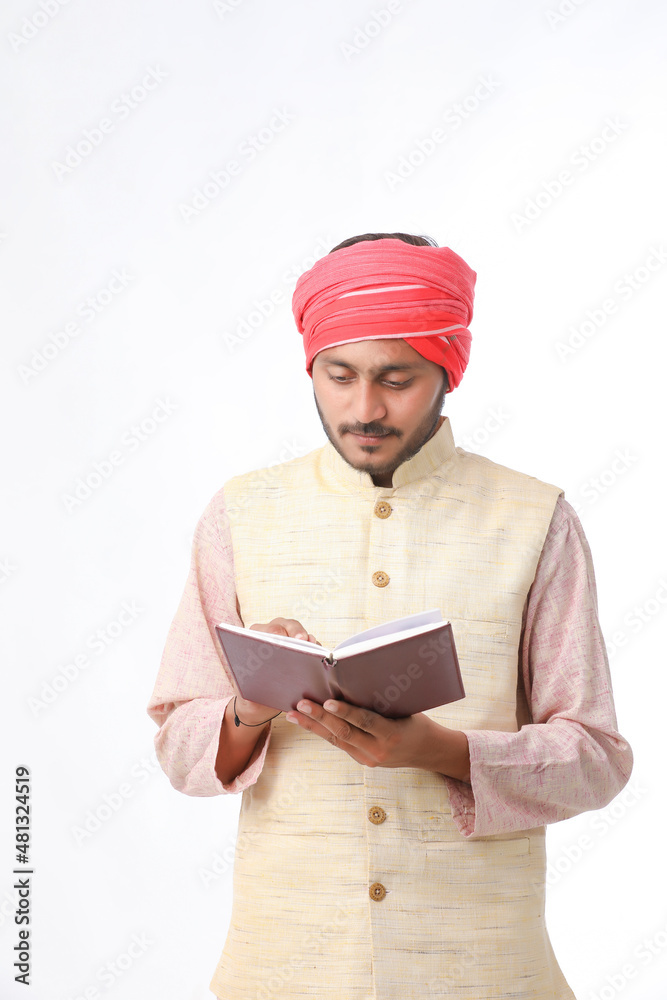 Indian farmer using diary on white background. Indian farmer using diary on white background.